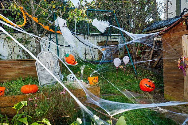 istock Empty Halloween yard scene with cobwebs, pumpkins, and ghosts 2243103812