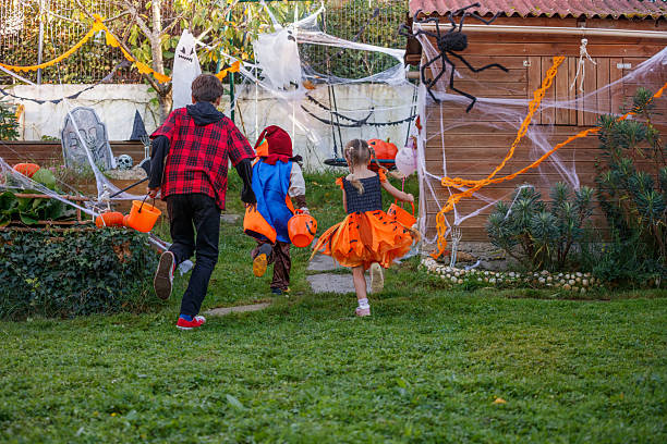 istock Children race through Halloween yard amid festive decorations 2243103813