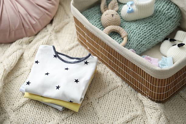 istock Baby clothes on sofa at home, closeup 2243106498