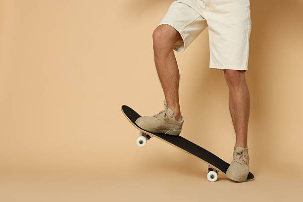 istock Man with skateboard on beige background, closeup. Space for text 2243111681