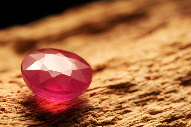 istock Beautiful shiny pink gemstone on stone, closeup. Space for text 2243112297