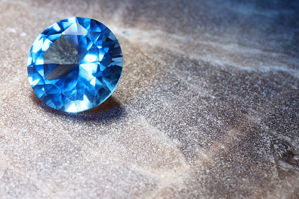 istock Beautiful shiny light blue gemstone on stone, space for text 2243112315