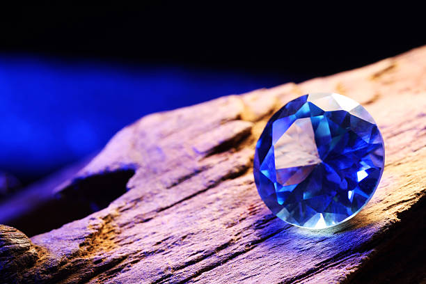 istock Beautiful shiny light blue gemstone on stone against dark background, closeup 2243112320