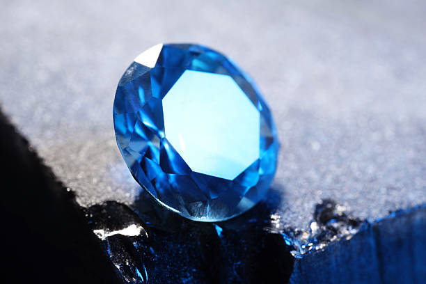 istock Beautiful shiny light blue gemstone on stone, closeup 2243112362