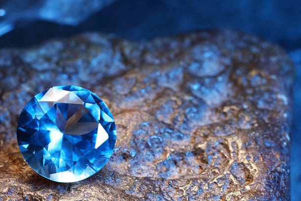 istock Beautiful shiny light blue gemstone on rock, closeup. Space for text 2243112385