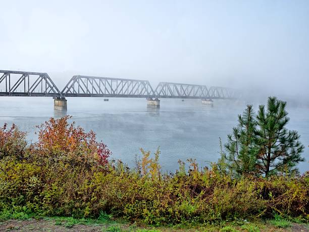 istock Bridge in foggy fall morning. 2243127953