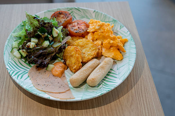 Healthy Breakfast Plate with Scrambled Eggs, Salad and Sausages