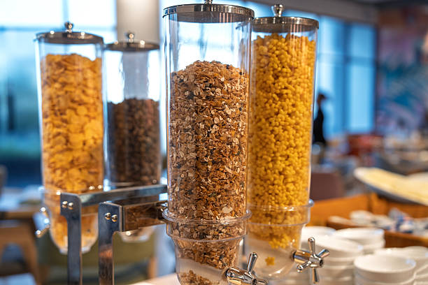 Assorted Breakfast Cereals in Transparent Dispensers at Buffet Station