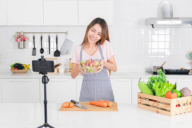 istock Woman in an apron present a fresh salad bowl. 2243134249