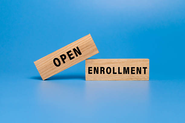 istock open enrollment words on wooden blocks isolated on blue background 2243138918