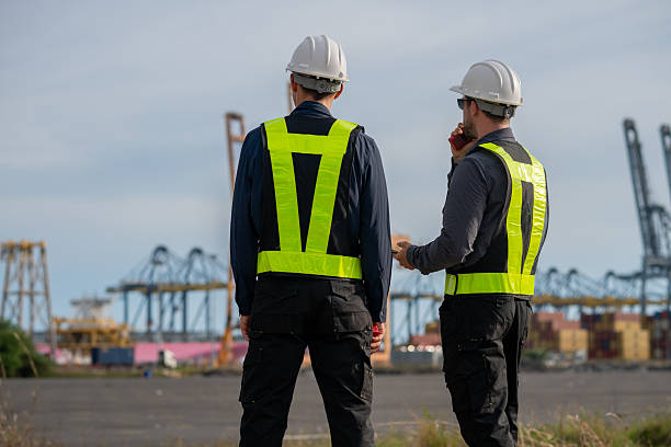 istock Industrial engineer workers operations marine port cranes loading and unloading of cargo ships global trade and supply chain import export environment monitoring responsible global economy. 2243139820