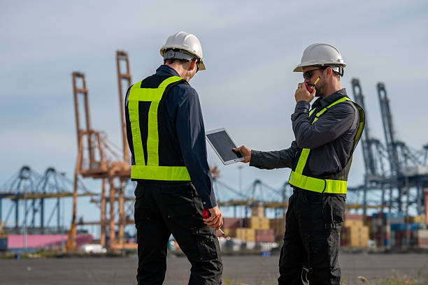 istock Industrial engineer workers operations marine port cranes loading and unloading of cargo ships global trade and supply chain import export environment monitoring responsible global economy. 2243139838
