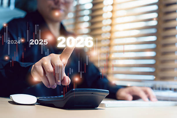 istock Businesswoman pointing at 2026 holographic candlestick chart. 2243141706