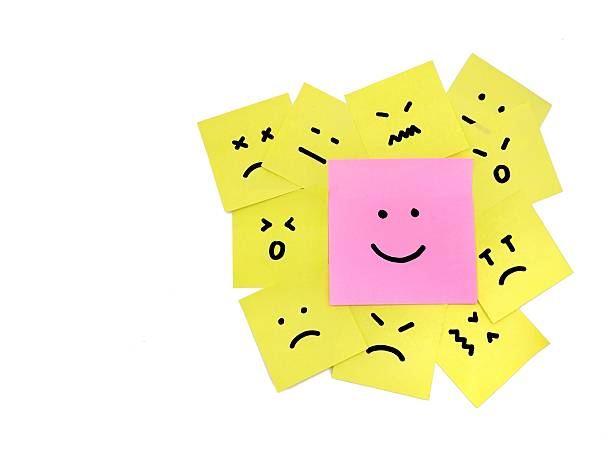 istock Hand drawn faces on sticky notes with on that stands out in a smile emoji 2243142810