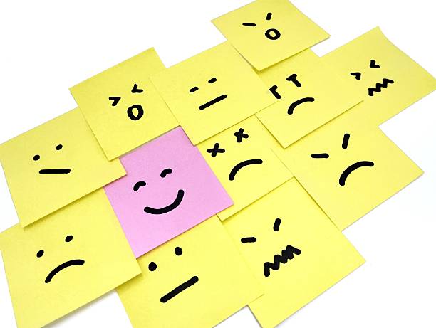 istock Hand drawn faces on sticky notes with on that stands out in a smile emoji 2243142822