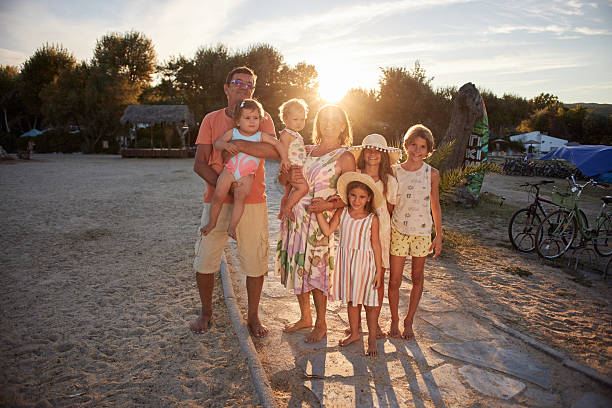 istock Family enjoying beach vacation at sunset during summer 2243142853