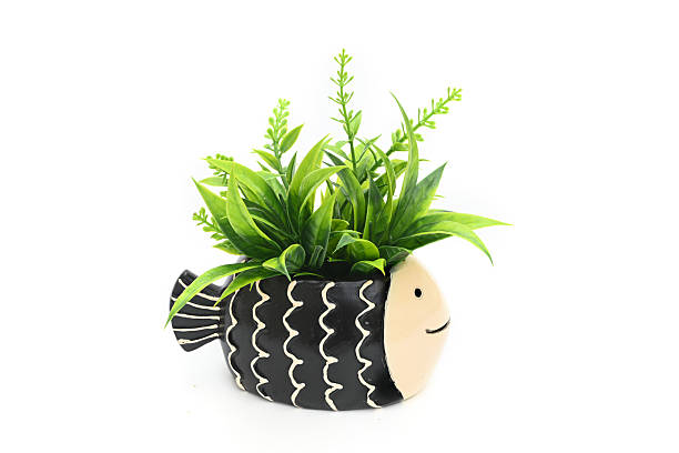 Decorative vase with artificial leaves isolated on white
