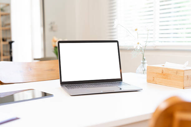 istock A modern laptop with a blank white screen on a clean white desk, perfect for digital mockups, against a bright, sunlit window background. 2243152703