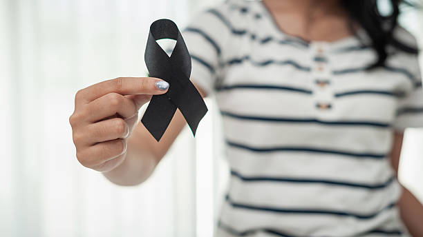 istock Memorial event featuring black ribbon symbol emotional gathering indoor setting supportive community 2243153033