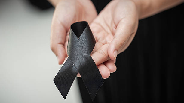 istock Funeral rituals and ribbons remembering departed with black tribute emotional setting 2243153128