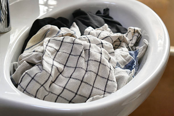 istock Dirty clothes in the basin or sink. 2243154605