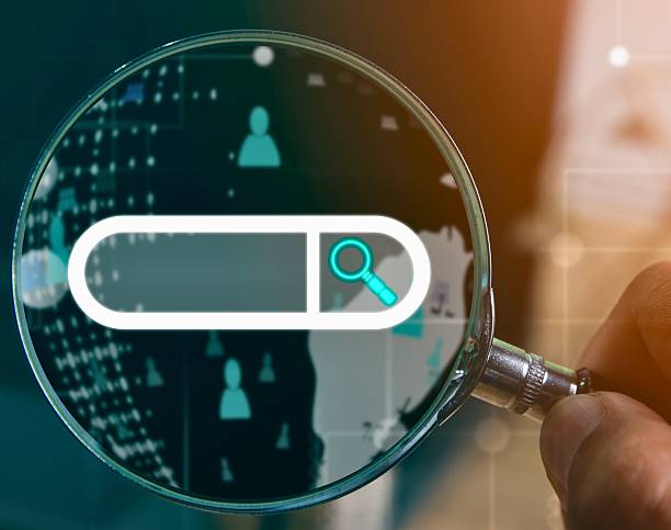 istock Magnifying glass over a digital search bar with user icons 2243159175