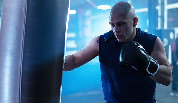 istock Focused boxer training with intensity, showcasing determination and strength in the gym environment. 2243159704