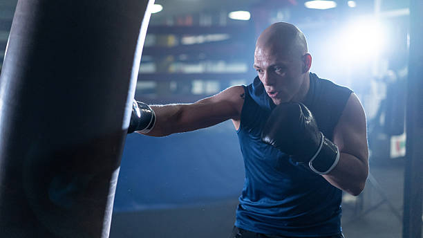 istock Focused boxer training with intensity, showcasing determination and strength in the gym environment. 2243159705