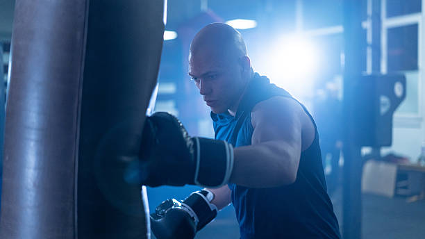istock Focused boxer training with intensity, showcasing determination and strength in the gym environment. 2243159724