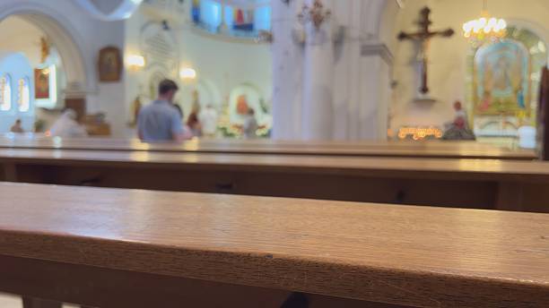 istock Believers in a Catholic church behind the benches. 2243162082