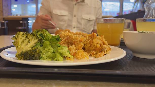 Broccoli with a dish of pilaf on the table while dining with friends
