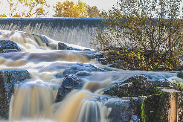 istock Artificial fish ladder in a river with water flowing over concrete steps, designed to help wild salmon migrate upstream through the dam, symbol of ecological restoration 2243163601