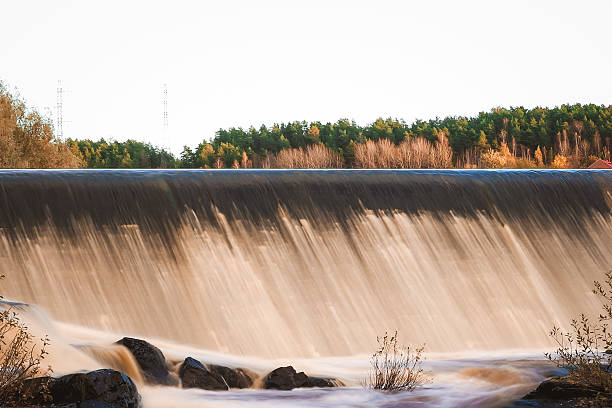 istock Artificial fish ladder in a river with water flowing over concrete steps, designed to help wild salmon migrate upstream through the dam, symbol of ecological restoration 2243163708