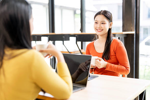 istock Two Asian colleagues enjoying a coffee break while having a productive business discussion in the office. 2243166605
