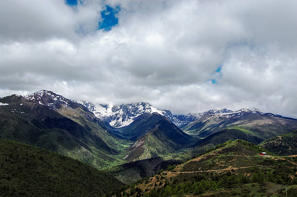 istock Majestic mountain range with snow-capped peaks under cloudy sky 2243169083