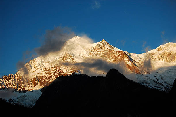 istock Snow-capped Mountain Peaks Under Clear Blue Sky 2243169156