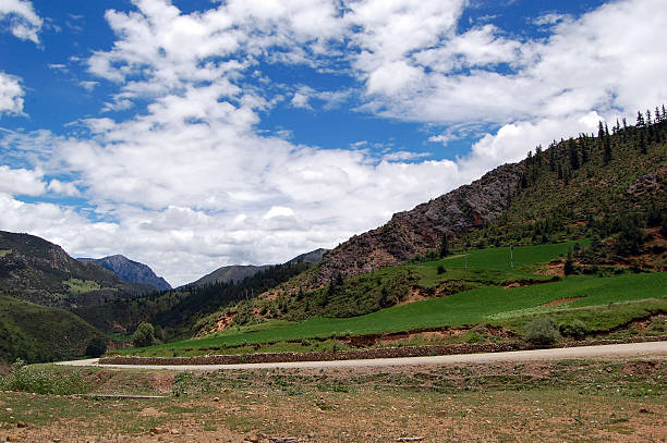istock Beautiful mountainous landscape with green fields and blue sky 2243169219