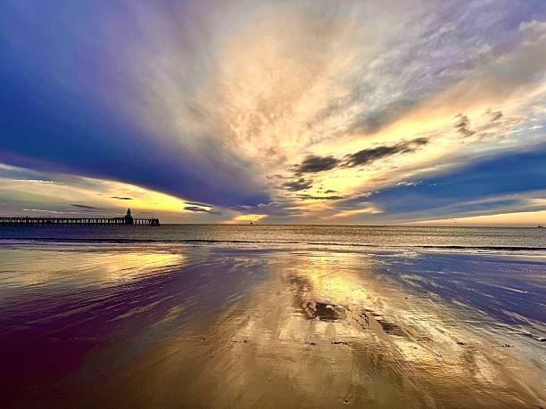 istock Dramatic cloudscape over the sea, a lighthouse and a pier at Blyth in Northumberland 2243170488