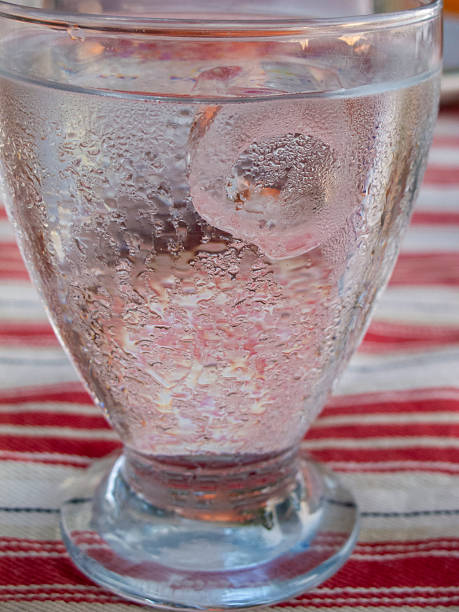 Ice cubes in glass of water
