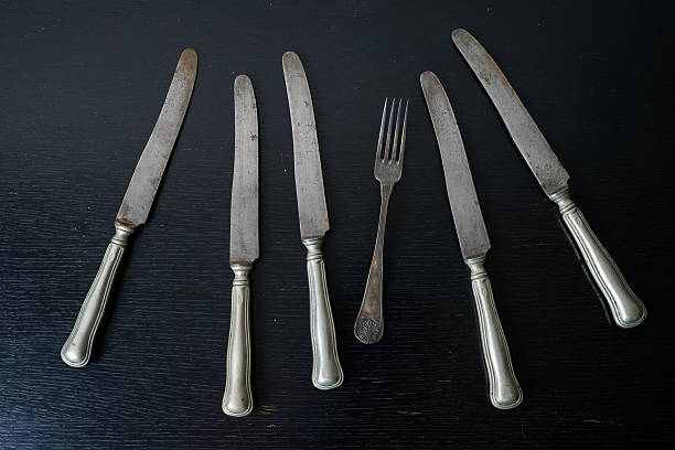 istock rusty silverware knife and fork on black furniture 2243175685