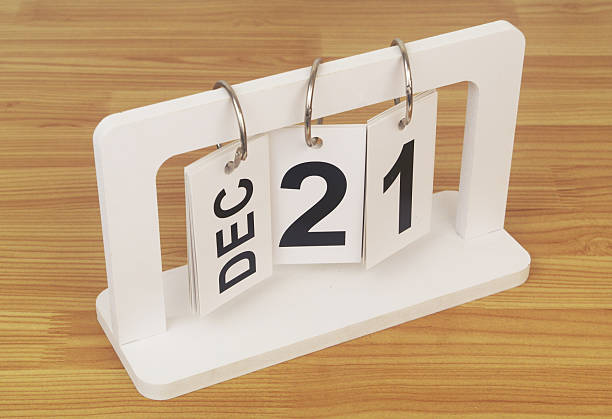 December, 21 on calendar on wooden table close up.