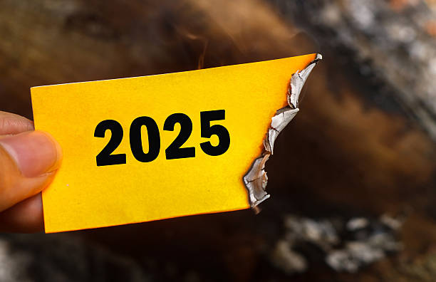 istock Hand holding a half-burnt note with 2025 written on it. Goodbye 2025 Concept and new year 2026 concept. 2025 paper is burning, saying goodbye to 2025 and welcoming the promise of 2026 2243183707