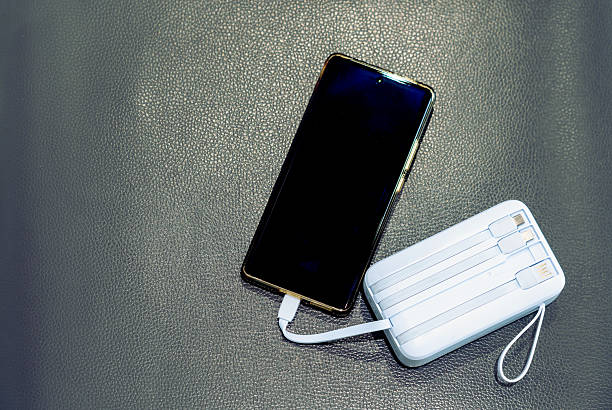 istock Charging your smartphone from a portable charger, close-up. 2243187015