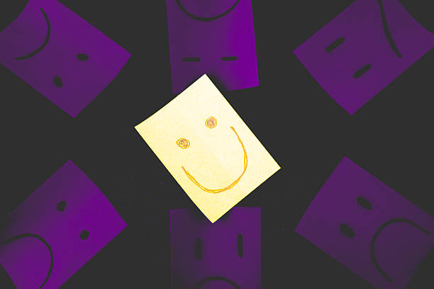 Happy Woman holding smile emotion face block. Customer choose Emoticon for user reviews. Service rating, mental health, positive thinking, satisfaction, evaluation and feedback concept