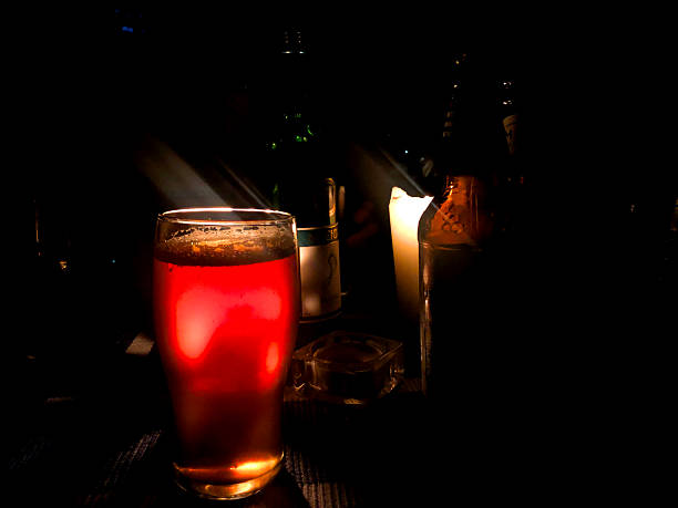 istock Glass of beer by candle light 2243188898