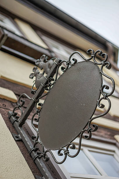 istock A sign with a bird on it is hanging on a building 2243191590