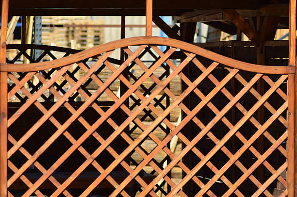 wooden batten fence in brown color in a yard