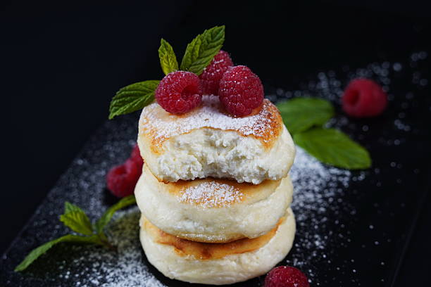 istock Sweet cottage cheese pancakes(sweet syrniki) on plate with raspberries 2243197947