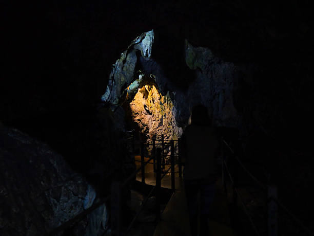 istock Traveler woman visiting a cave. 2243199921