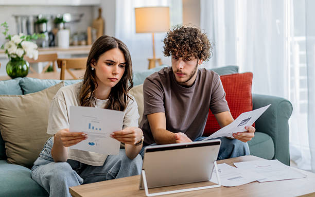 istock Couple reviewing budget, worrying about finances at home 2243201972